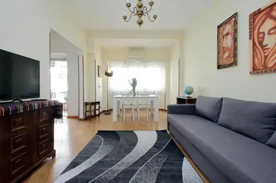 a living room with a couch and a tv and a table at 4BNB - Cipro Vatican Apartment in Rome