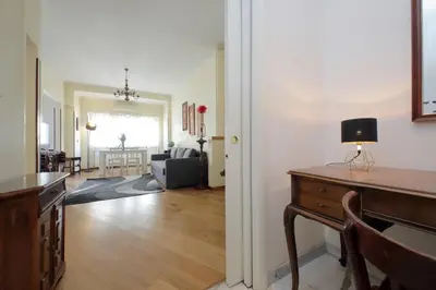 an open living room with a desk and a living room at 4BNB - Cipro Vatican Apartment in Rome