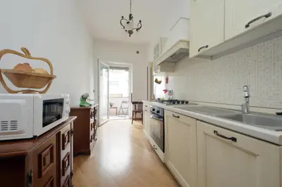 a kitchen with a sink and a microwave at 4BNB - Cipro Vatican Apartment in Rome