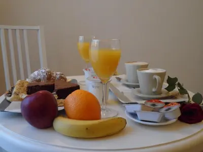 a table with fruit and two glasses of orange juice at Dante's in Vaticano in Rome