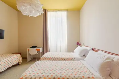 a hotel room with two beds and a window at B&B L'Amaca in Rome