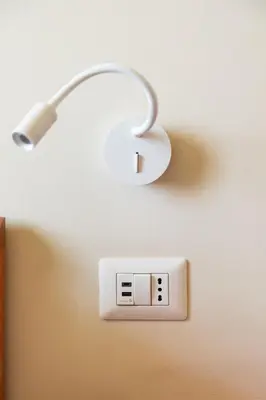 a light attached to a wall with a light switch at B&B L'Amaca in Rome