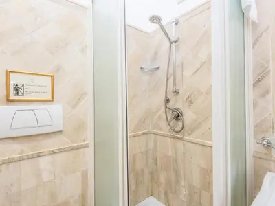 a shower with a glass door in a bathroom at Il Gattopardo Relais in Rome