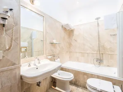 a bathroom with a sink and a toilet and a tub at Il Gattopardo Relais in Rome