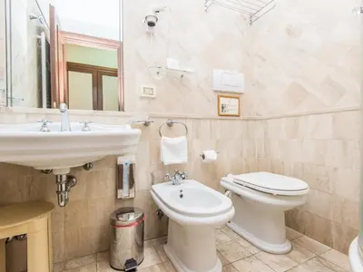 a bathroom with a sink and a toilet and a mirror at Il Gattopardo Relais in Rome