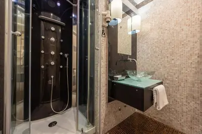 a bathroom with a sink and a glass shower at Al Viminale Hill Inn & Hotel in Rome