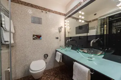 a bathroom with two sinks and a toilet at Al Viminale Hill Inn & Hotel in Rome