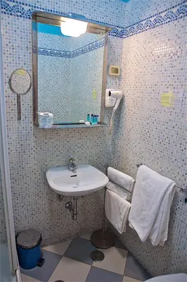a bathroom with a sink and a mirror at Hotel Carmel in Rome
