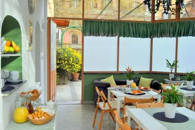 a dining room with a table and chairs in a room at Hotel Carmel in Rome