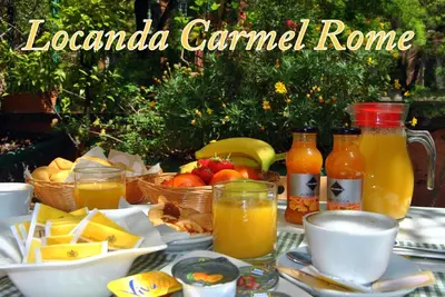 a table with food and drinks and baskets of fruit at Hotel Carmel in Rome