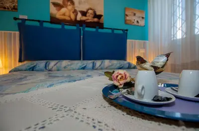 a bedroom with a bed with a table with two laptops at Passeggiate Romane in Rome