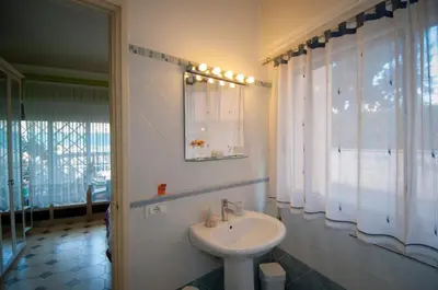 a bathroom with a sink and a mirror at Passeggiate Romane in Rome