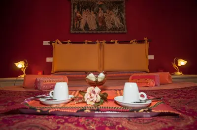 a room with a table with two cups and a tray of food at Passeggiate Romane in Rome