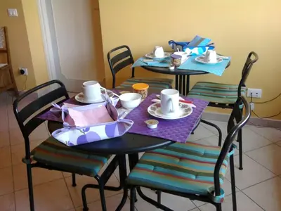 two tables and chairs with plates and cups on them at Passeggiate Romane in Rome