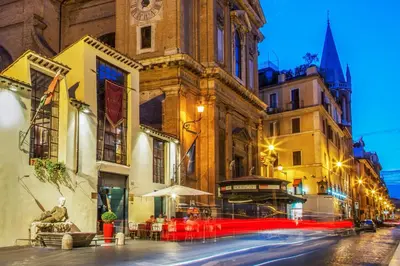 a city street with a building with a clock tower at Residenza Canova Tadolini - Guesthouse in Rome