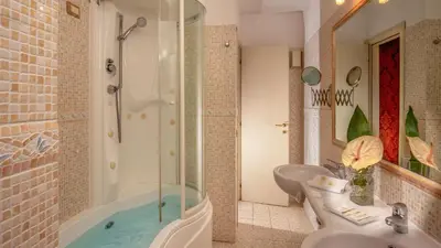 a bathroom with a shower and a tub and a sink at Residenza Canova Tadolini - Guesthouse in Rome