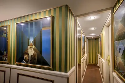 a hallway with green and yellow striped walls at Residenza Canova Tadolini - Guesthouse in Rome