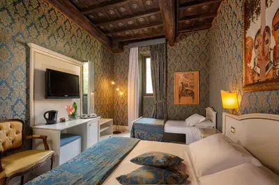 a hotel room with two beds and a television at Residenza Canova Tadolini - Guesthouse in Rome
