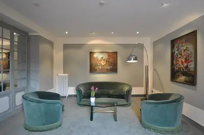 a living room with two chairs and a couch at Hotel Gregoriana in Rome