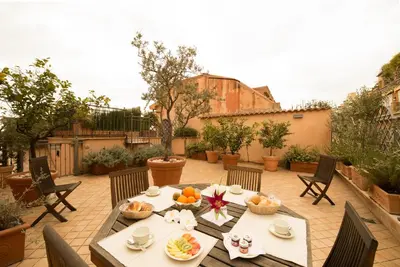 a table with bowls of fruit on a patio at Hotel Gregoriana in Rome