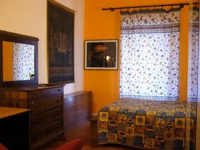 a bedroom with a bed and a dresser and a window at B&B&Courtesy in Rome