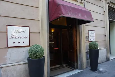 a hotel miranza with twoiaries outside of a building at Hotel Mariano in Rome