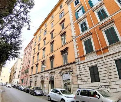 a building with cars parked on the side of a street at Hotel Mariano in Rome