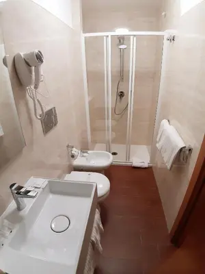 a bathroom with a shower and a toilet and a sink at Hotel Mariano in Rome
