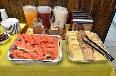 a table with two trays of bread and watermelon sandwiches at Hotel Tex in Rome