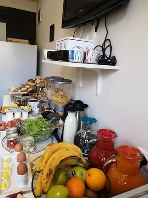 a kitchen counter with a bunch of fruits and vegetables at Mia Suites in Rome