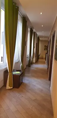 a hallway with green curtains and a floor with a room with a hallwayngth at Mia Suites in Rome