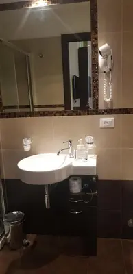 a bathroom with a white sink and a mirror at Mia Suites in Rome