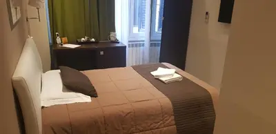 a bedroom with a bed with two towels on it at Mia Suites in Rome