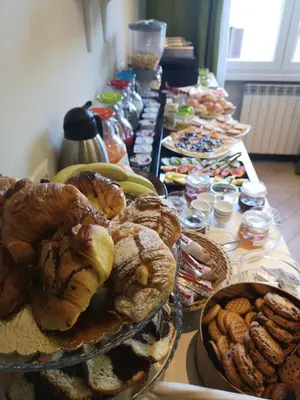 a long buffet of bread and pastries on a table at Mia Suites in Rome