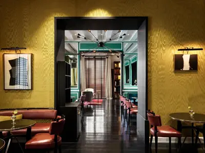 a dining room with tables and chairs and yellow walls at J.K. Place Roma - The Leading Hotels of the World in Rome