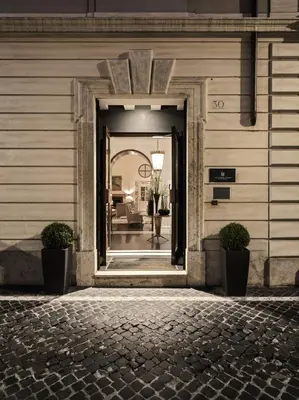 a doorway to a building with a person walking into it at J.K. Place Roma - The Leading Hotels of the World in Rome