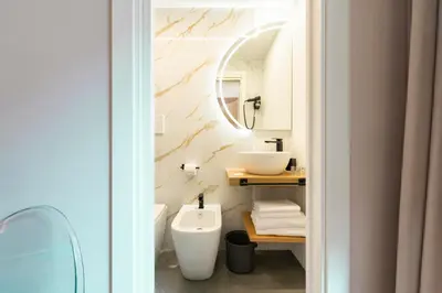 a bathroom with a sink and a toilet and a mirror at Hotel Magic in Rome