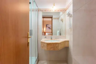 a bathroom with a sink and a mirror at Hotel Magic in Rome