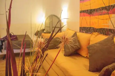 a living room with a couch with pillows at Hotel Novecento in Rome