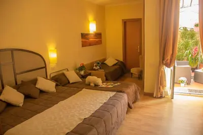 a bedroom with a large bed and a couch at Hotel Novecento in Rome