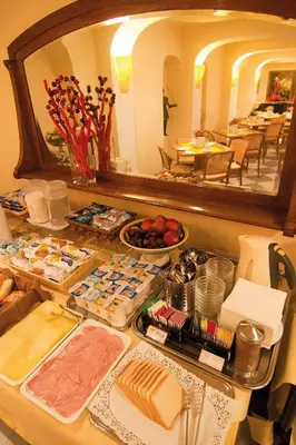 a buffet with many different types of food on a table at Hotel Novecento in Rome