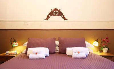 a bedroom with a bed with white pillows at Campanella3 in Rome