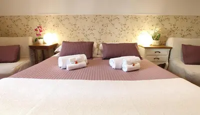 a bedroom with a large white bed with two pillows at Campanella3 in Rome