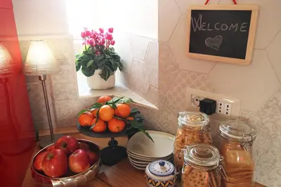 a table with a bowl of fruit and a plate of apples at Campanella3 in Rome