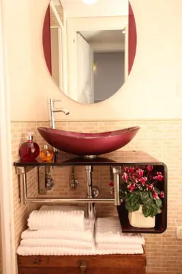 a bathroom with a red sink and a mirror at Campanella3 in Rome