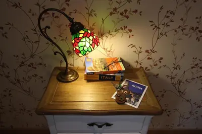 a table with a lamp and books on it at Campanella3 in Rome