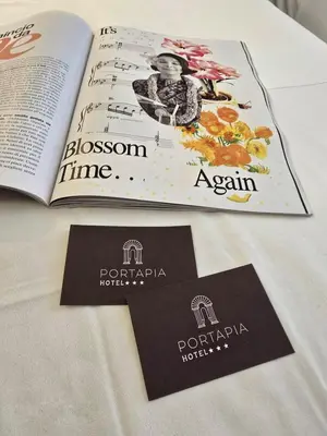 two brochures on a table with a book at Hotel Porta Pia in Rome