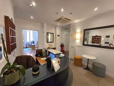 a office with a desk and a table in a room at Hotel Porta Pia in Rome