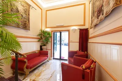 a waiting room with red couches and a window at Residenza Antica Roma in Rome
