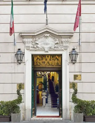 a entrance to a store with two flags over the door at Residenza Antica Roma in Rome